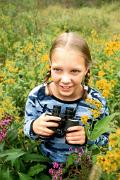Birder - girl with binoculars in field with flowers D 19452k